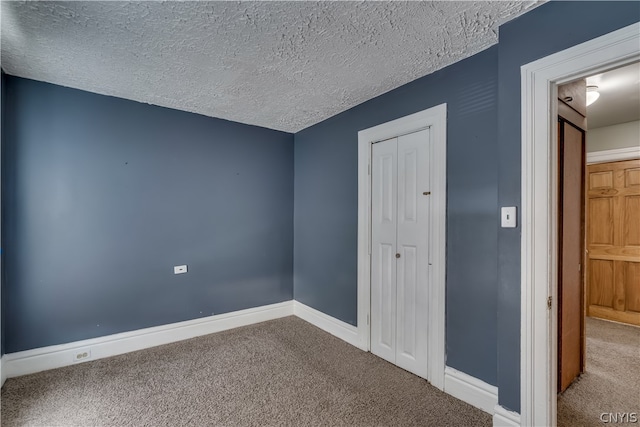 unfurnished bedroom with a closet, carpet flooring, and a textured ceiling