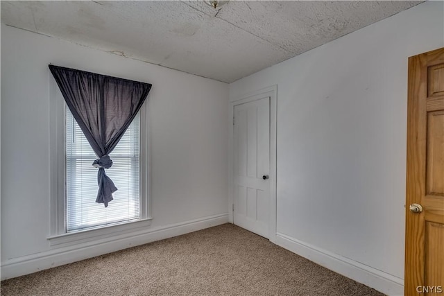 unfurnished room featuring light colored carpet