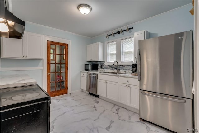 kitchen with appliances with stainless steel finishes, white cabinetry, light tile patterned floors, and sink