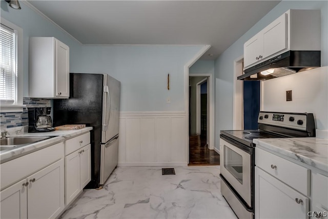 kitchen featuring tasteful backsplash, appliances with stainless steel finishes, light stone counters, and white cabinets