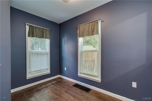 empty room with hardwood / wood-style flooring