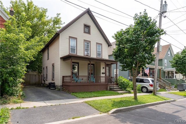 view of front of property with a porch and central AC unit