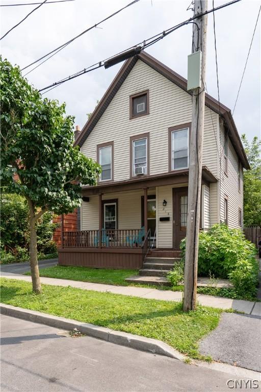 view of front of house featuring a porch and a front lawn