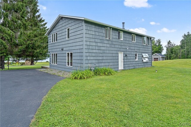 view of home's exterior with a yard