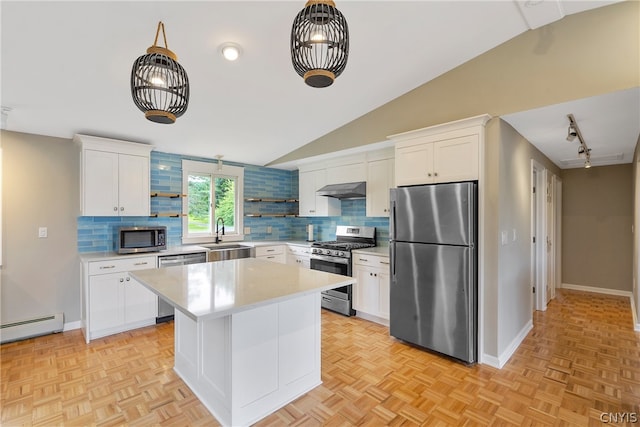 kitchen featuring appliances with stainless steel finishes, vaulted ceiling, and light parquet floors