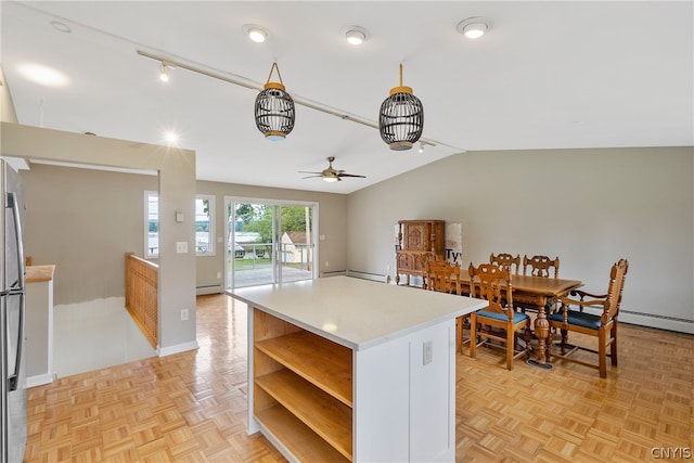 kitchen with ceiling fan, lofted ceiling, a baseboard heating unit, and light parquet floors