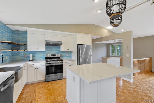 kitchen featuring a center island, decorative backsplash, appliances with stainless steel finishes, and light parquet floors