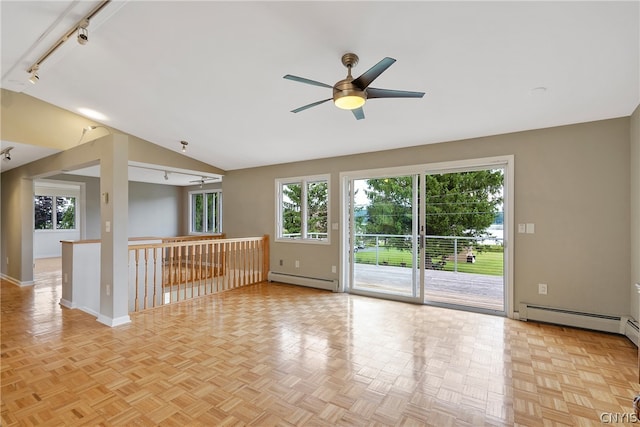 empty room with ceiling fan, vaulted ceiling, a baseboard radiator, and light parquet floors