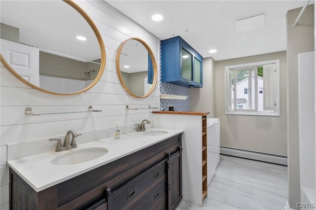 bathroom with tile patterned flooring, baseboard heating, and vanity