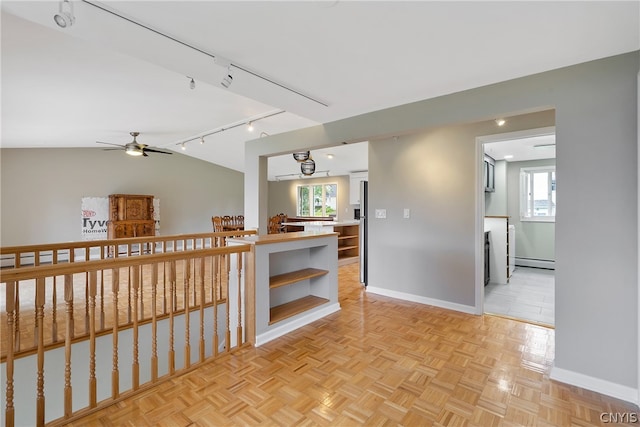 kitchen featuring ceiling fan, track lighting, a healthy amount of sunlight, and light parquet floors