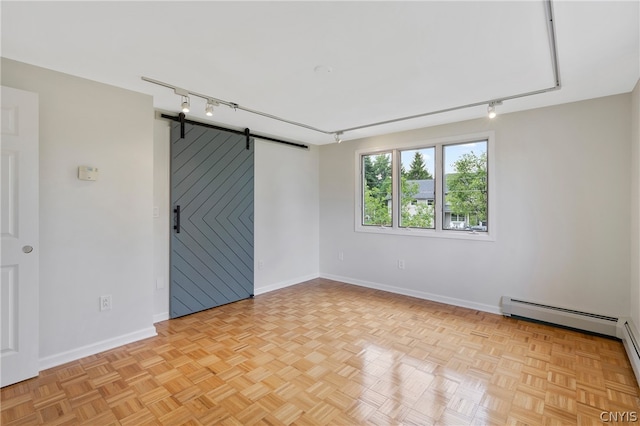 unfurnished room featuring a baseboard radiator, a barn door, and light parquet floors