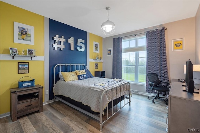 bedroom with hardwood / wood-style floors