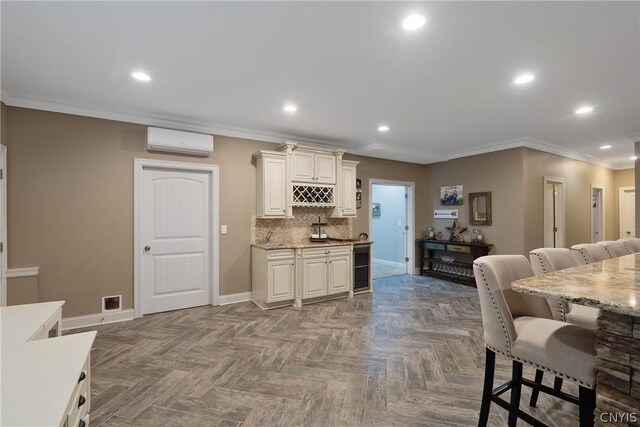 kitchen with a kitchen bar, tasteful backsplash, a wall mounted air conditioner, parquet floors, and ornamental molding