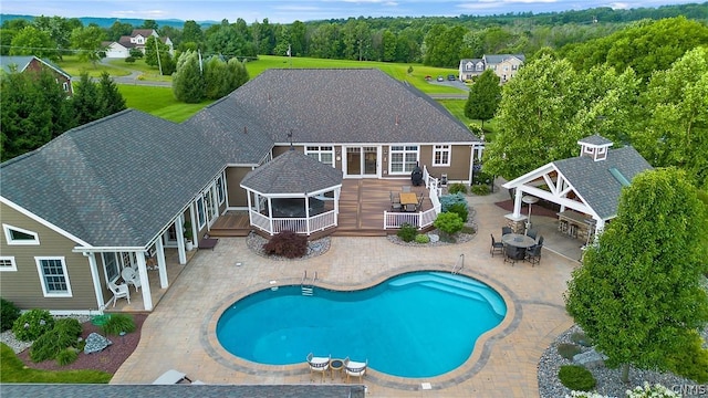 view of swimming pool with a wooden deck and a gazebo