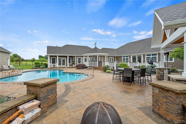 view of pool featuring an outdoor fire pit and a patio area