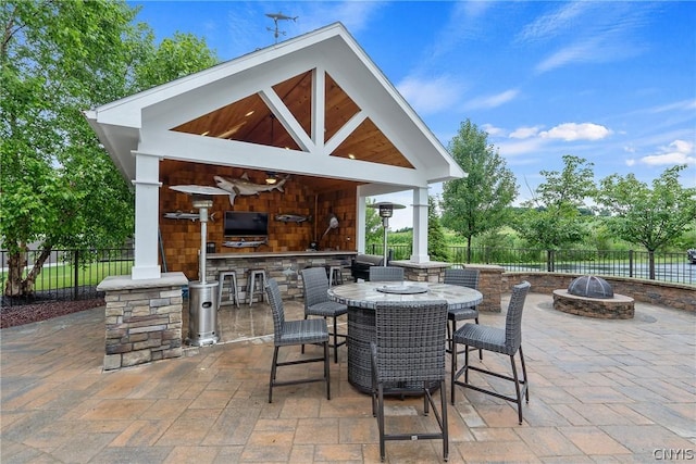 view of patio / terrace with a gazebo, an outdoor bar, and a fire pit