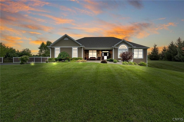 ranch-style house featuring a lawn