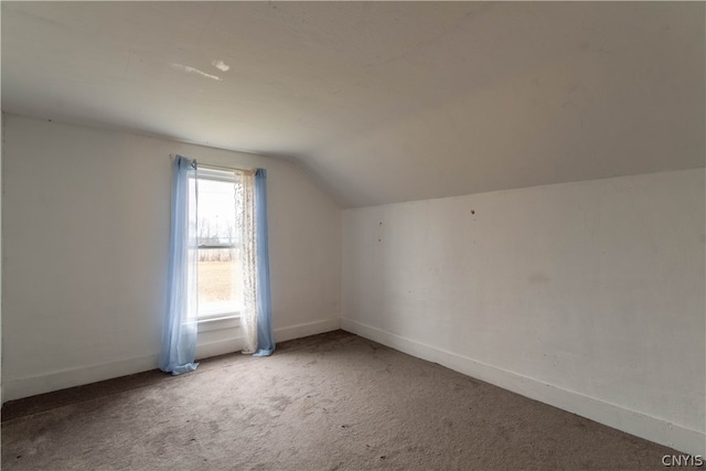 bonus room featuring carpet flooring and vaulted ceiling