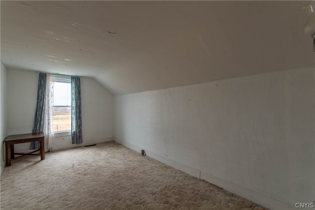 bonus room with carpet floors and vaulted ceiling