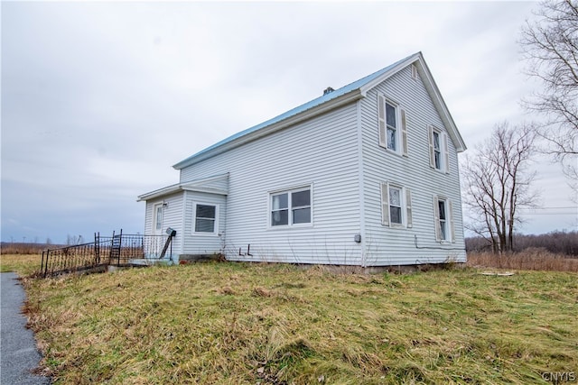 rear view of house with a yard