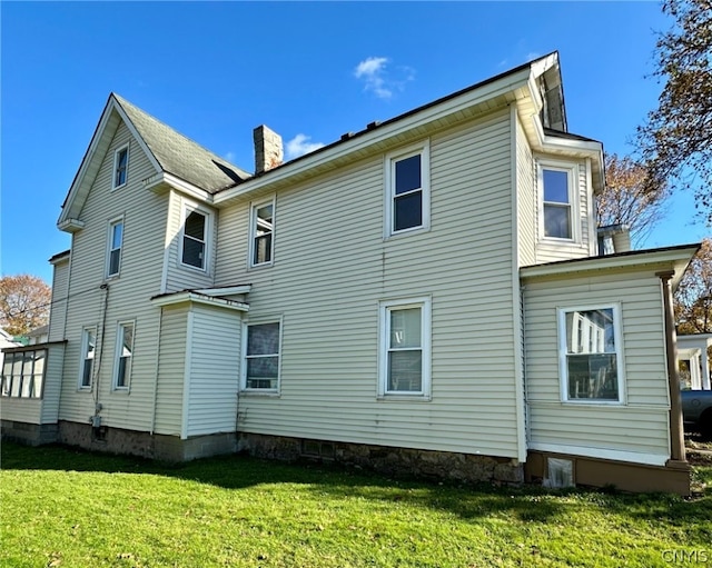 back of property featuring a lawn