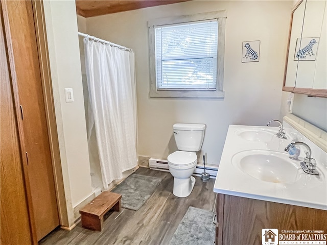 bathroom with a shower with shower curtain, hardwood / wood-style floors, vanity, and toilet