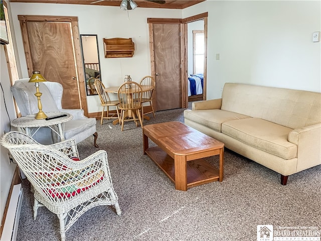 living room with a baseboard heating unit, ceiling fan, and carpet floors