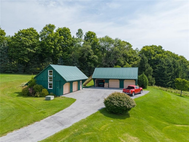 94 Overlook Dr, Andes, NY 13731 - view of front of home featuring a detached garage, a front yard, an outbuilding, and metal roof