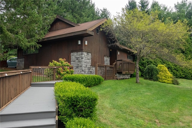 view of side of property with a lawn and a deck