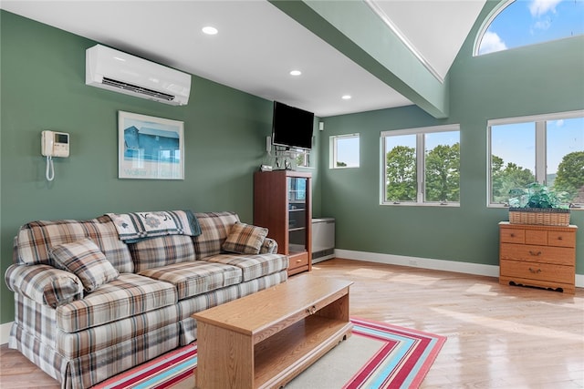 living room featuring light wood-type flooring and an AC wall unit