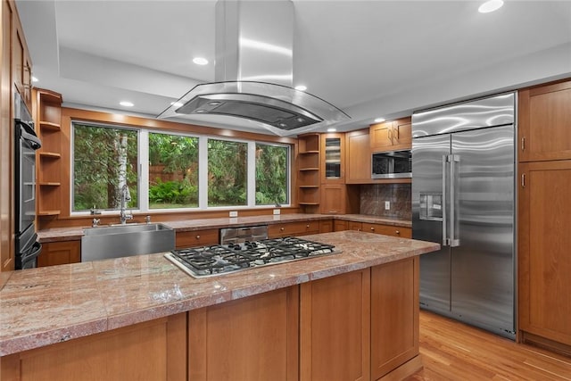 94 Overlook Dr, Andes, NY 13731 - kitchen with appliances with stainless steel finishes, open shelves, island exhaust hood, a sink, and brown cabinetry
