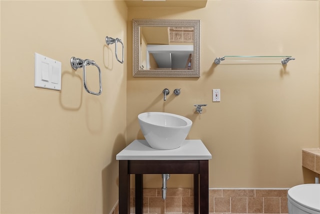 bathroom featuring sink, tile patterned flooring, and toilet