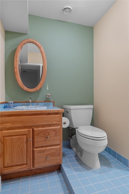 bathroom featuring vanity, toilet, and tile patterned floors