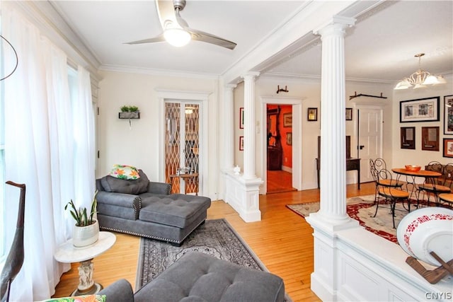 living room with ornamental molding, decorative columns, light hardwood / wood-style floors, and ceiling fan