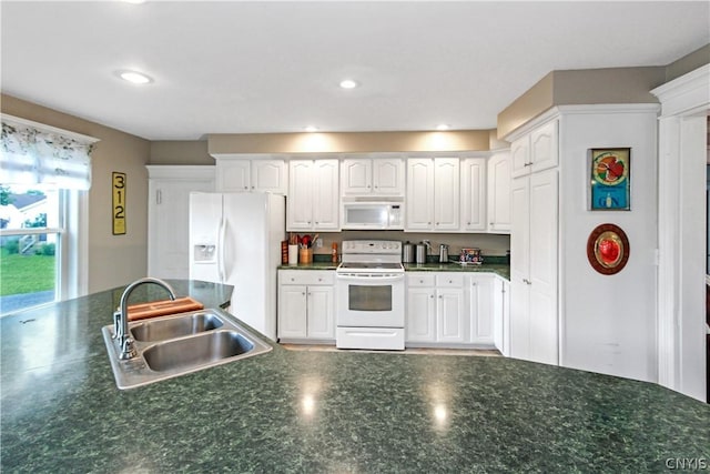 kitchen with white appliances, sink, and white cabinets