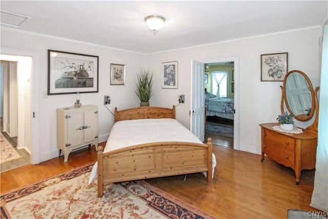 bedroom featuring ornamental molding and hardwood / wood-style floors