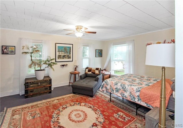 bedroom with ornamental molding and ceiling fan