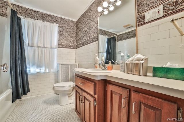 full bathroom with tile walls, shower / bath combo, toilet, tile patterned floors, and vanity