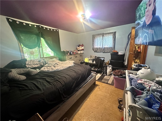 bedroom with hardwood / wood-style flooring