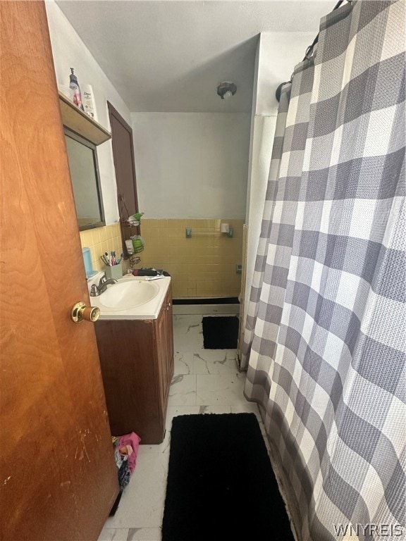 bathroom featuring vanity, decorative backsplash, tile patterned flooring, and tile walls