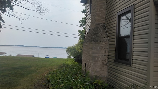 exterior space with a yard and a water view