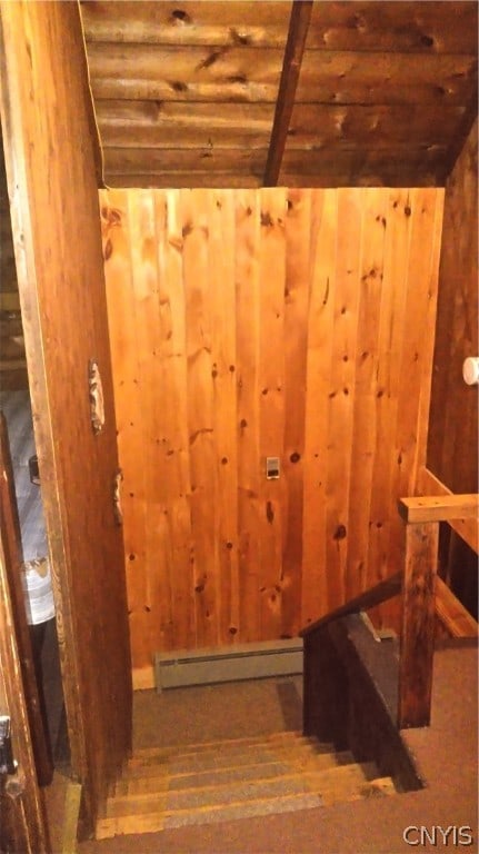 stairway featuring a baseboard radiator and hardwood / wood-style floors