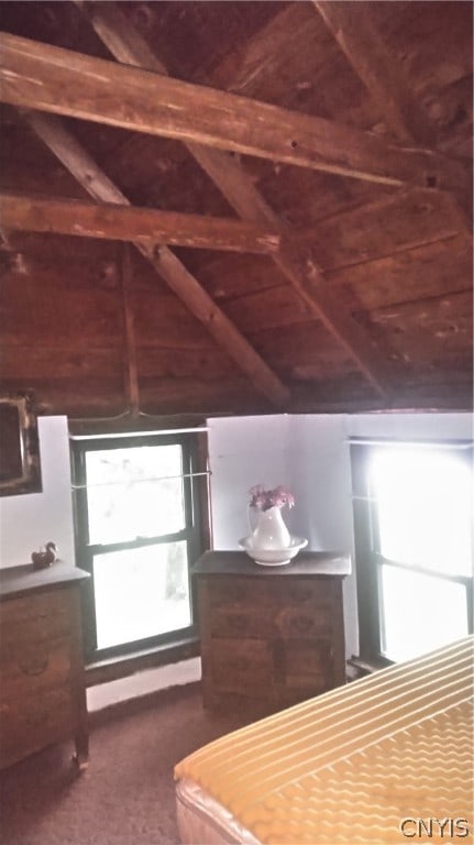 unfurnished bedroom with vaulted ceiling with beams and wood ceiling