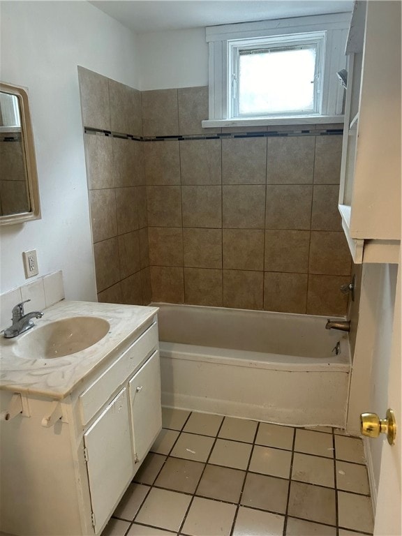 bathroom with tile patterned floors, tiled shower / bath combo, and vanity