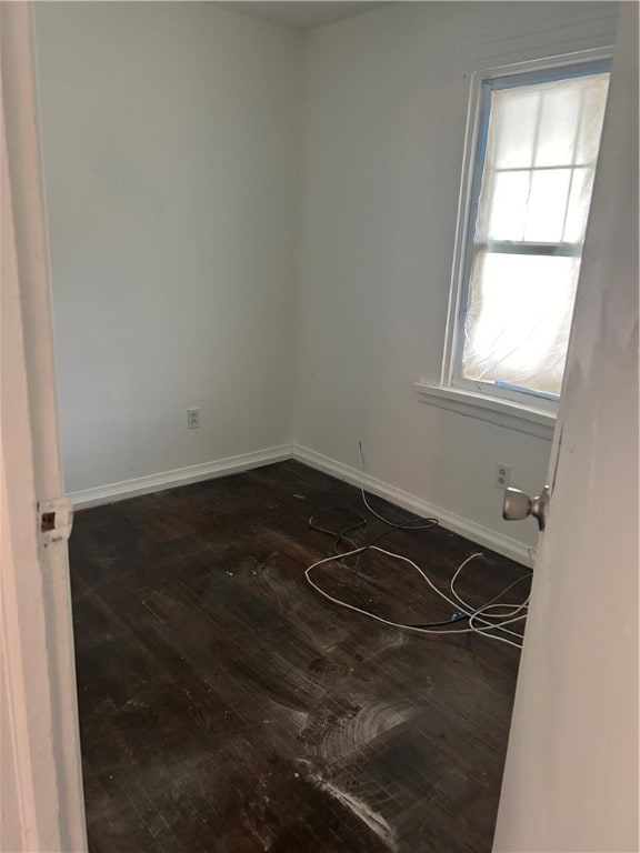 unfurnished room featuring hardwood / wood-style flooring