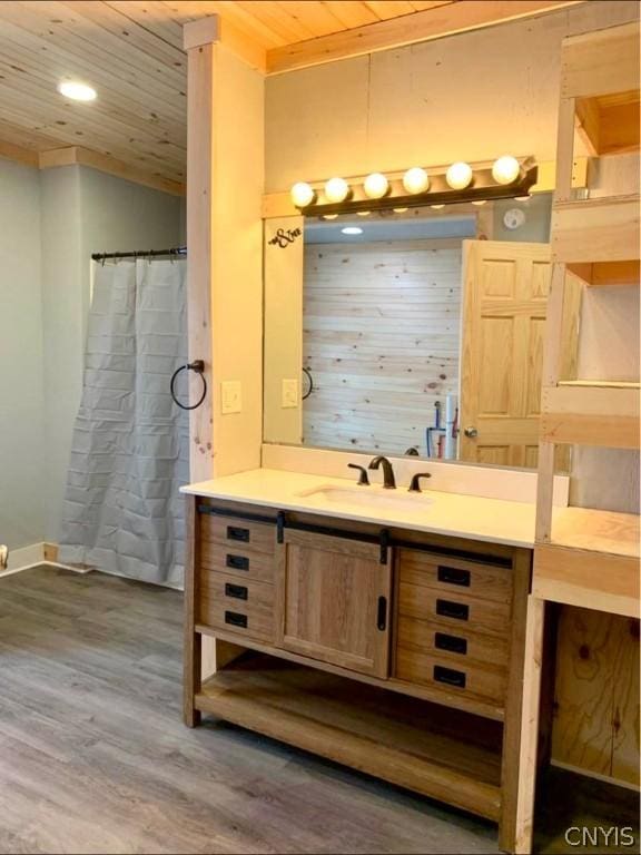 bathroom featuring vanity, hardwood / wood-style floors, and wood ceiling