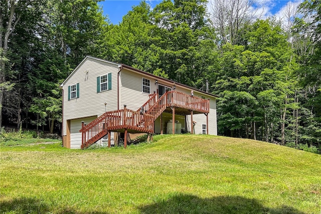 view of front of property featuring a deck, stairs, and a front lawn