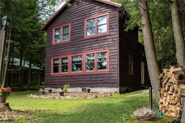 view of side of home featuring a lawn