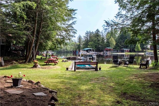 view of yard with a boat dock and a water view