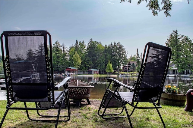 view of playground with a water view and a lawn